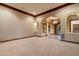 Expansive living area with carpet flooring, arched doorways, and recessed lighting at 3523 E Presidio Cir, Mesa, AZ 85213
