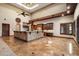 Open living room with access to the kitchen, tile flooring, and high ceilings at 3523 E Presidio Cir, Mesa, AZ 85213