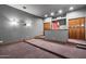 Home theater room features tiered seating, sconces, and built-in storage at 3523 E Presidio Cir, Mesa, AZ 85213