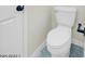Close up of toilet with white door at 3650 E Laurel Ln, Phoenix, AZ 85028