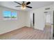 Bedroom featuring wood look floors and large window at 3650 E Laurel Ln, Phoenix, AZ 85028