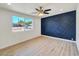 Stylish bedroom with modern accent wall and hardwood floors for a sleek design at 3650 E Laurel Ln, Phoenix, AZ 85028