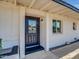 Close-up of the entryway with modern door and clean, white-painted facade at 3650 E Laurel Ln, Phoenix, AZ 85028