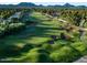 Scenic view of the golf course and sand traps with trees and mountains in the background at 3650 E Laurel Ln, Phoenix, AZ 85028