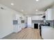 Modern kitchen featuring white cabinetry, stainless steel appliances and sleek flooring at 3650 E Laurel Ln, Phoenix, AZ 85028