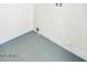 A utility room with painted floors and a laundry hook-up on the wall at 3650 E Laurel Ln, Phoenix, AZ 85028