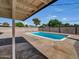 A backyard with a refreshing pool surrounded by concrete and decorative rock at 3650 E Laurel Ln, Phoenix, AZ 85028