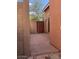 Private backyard patio area enclosed with block walls and a wooden gate at 3756 E Kerry Ln, Phoenix, AZ 85050