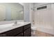 Bathroom featuring a large vanity, tile flooring, a shower-tub combo, and a white toilet at 3756 E Kerry Ln, Phoenix, AZ 85050