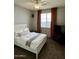 Well-lit bedroom featuring a comfortable bed, ceiling fan, and neutral decor at 3756 E Kerry Ln, Phoenix, AZ 85050