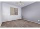 Neutral bedroom has carpet flooring, a ceiling fan, and a light gray accent wall at 3756 E Kerry Ln, Phoenix, AZ 85050