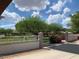 Exterior shot of community entrance showcasing manicured landscaping and trees at 3756 E Kerry Ln, Phoenix, AZ 85050