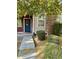 Charming home featuring a blue front door, stone accents, manicured bushes, and sidewalk leading to entrance at 3756 E Kerry Ln, Phoenix, AZ 85050