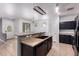 The kitchen has a tan counter island, a black double sink, and views to the entry way at 3756 E Kerry Ln, Phoenix, AZ 85050