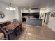 Spacious dining area adjacent to the kitchen featuring tile floors, a dining table, and black cabinets at 3756 E Kerry Ln, Phoenix, AZ 85050
