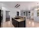 Open kitchen with a black sink, tan counters, tile flooring, and views to the living room at 3756 E Kerry Ln, Phoenix, AZ 85050