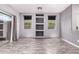 Bright living room with stylish wood laminate flooring, built-in shelving, and sliding glass door to the patio at 3756 E Kerry Ln, Phoenix, AZ 85050