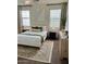 This staged main bedroom with carpet has many windows with natural light, and curated decor at 3756 E Kerry Ln, Phoenix, AZ 85050