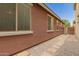 Exterior side yard with pavers and stone, leading to a gate for access at 3756 E Kerry Ln, Phoenix, AZ 85050