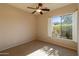 Neutral bedroom featuring a ceiling fan, a window and neutral carpet at 4241 E Andre Ave, Gilbert, AZ 85298
