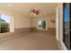 Large carpeted bonus room with wainscotting, windows, and a ceiling fan at 4241 E Andre Ave, Gilbert, AZ 85298
