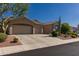 Charming single-Gathering home featuring desert landscaping, three-car garage, and a neutral color palette at 4241 E Andre Ave, Gilbert, AZ 85298