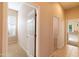 Hallway with neutral walls and doors leading to the bedroom and other rooms at 4241 E Andre Ave, Gilbert, AZ 85298