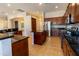 Modern kitchen featuring stainless steel appliances, granite countertops, and dark wood cabinetry at 4241 E Andre Ave, Gilbert, AZ 85298