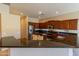 Beautiful kitchen featuring dark cabinets, stainless steel appliances, granite countertops, and modern fixtures at 4241 E Andre Ave, Gilbert, AZ 85298