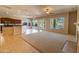 Inviting open-concept living space featuring carpet flooring, a fireplace, and a view of the backyard pool at 4241 E Andre Ave, Gilbert, AZ 85298