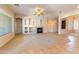 Spacious living room with fireplace, neutral carpet, and seamless transition to the adjoining rooms at 4241 E Andre Ave, Gilbert, AZ 85298