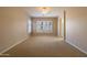 Spacious main bedroom with neutral carpet, large windows, ceiling fan and adjoining bath and closet at 4241 E Andre Ave, Gilbert, AZ 85298