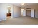 Carpeted main bedroom featuring arched doorways to bathroom and walk-in closet at 4241 E Andre Ave, Gilbert, AZ 85298