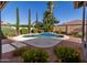 Backyard pool with a small waterfall feature, surrounded by lush landscaping and tall trees at 4241 E Andre Ave, Gilbert, AZ 85298