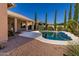 Beautiful backyard featuring a pool, covered patio, and desert landscaping at 4241 E Andre Ave, Gilbert, AZ 85298