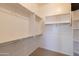 Spacious walk-in closet with carpet, overhead lights and closet organization system at 4241 E Andre Ave, Gilbert, AZ 85298
