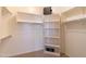 Well-organized walk-in closet featuring built-in shelves, rods, and carpeting at 4241 E Andre Ave, Gilbert, AZ 85298