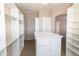 Expansive walk-in closet with central island, hanging rods and built in shelves at 4241 E Andre Ave, Gilbert, AZ 85298