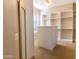 Large walk-in closet with built in shelving, drawers and dresser with full length mirror at 4241 E Andre Ave, Gilbert, AZ 85298