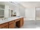 Bathroom featuring dual sinks, soaking tub, glass block window, and vanity area at 4446 E Woodridge Dr, Phoenix, AZ 85032