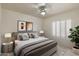 Neutral bedroom with a king-size bed, shuttered windows, bedside tables, and modern art at 4446 E Woodridge Dr, Phoenix, AZ 85032