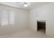Bright bedroom with neutral carpet, ceiling fan, and closet space under an opening at 4446 E Woodridge Dr, Phoenix, AZ 85032