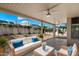 Relaxing covered patio with comfortable seating and a view of the landscaped backyard at 4446 E Woodridge Dr, Phoenix, AZ 85032