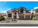 Beautiful two-story home featuring a well-manicured front yard, tiled roof, and attached two-car garage, under a blue sky at 4446 E Woodridge Dr, Phoenix, AZ 85032