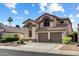 Charming two-story home with a tile roof, arched entryway, and a two-car garage in a well-maintained neighborhood at 4446 E Woodridge Dr, Phoenix, AZ 85032