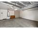 Spacious garage with ample storage cabinets, utility sink, and insulated ceiling at 4446 E Woodridge Dr, Phoenix, AZ 85032