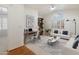 Office and living area featuring a modern desk, bookshelf, and comfortable white couch at 4446 E Woodridge Dr, Phoenix, AZ 85032