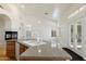 Bright kitchen with granite counters, white cabinets, and modern sink, plus a fireplace in the background at 4446 E Woodridge Dr, Phoenix, AZ 85032