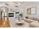 Bright living room with high ceilings, a fireplace, and a comfortable neutral sofa at 4446 E Woodridge Dr, Phoenix, AZ 85032