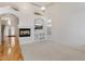 Bright living room featuring modern fireplace, neutral carpet, and open layout at 4446 E Woodridge Dr, Phoenix, AZ 85032